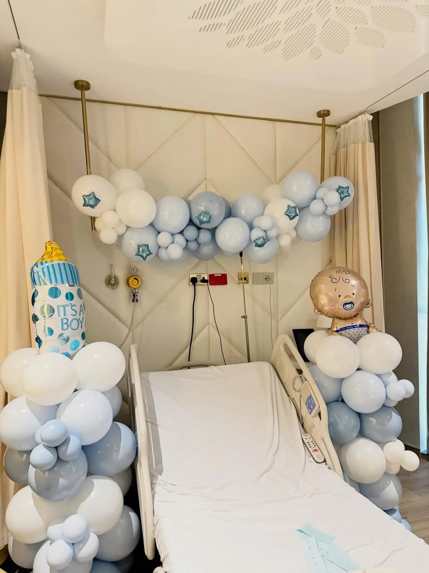 Hospital baby welcome decoration with pastel balloons and floral touches