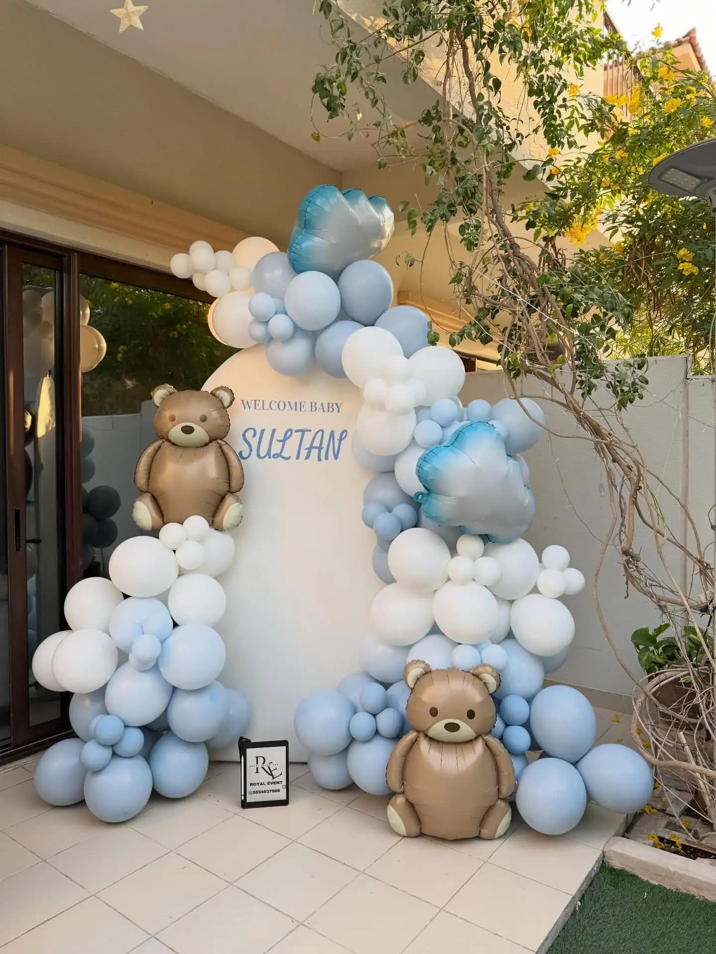 Baby welcome decoration in hospital room with balloon arch and name board